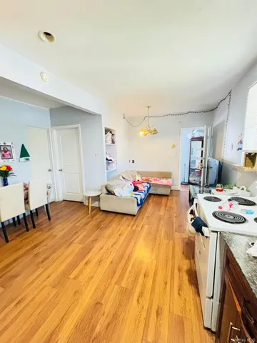 a playing room with furniture and a wooden floor