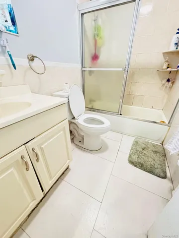a white toilet sitting next to a bathroom sink
