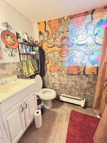 a bathroom with a sink a toilet and shower curtain