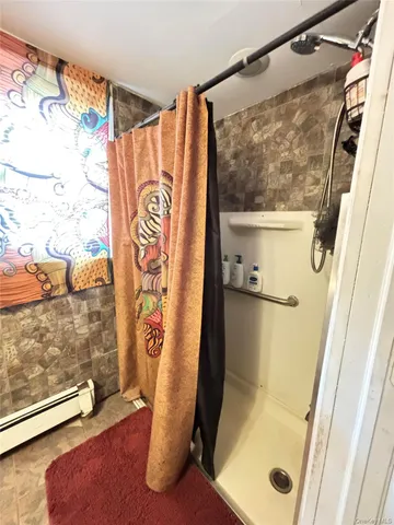 a bathroom with a shower and a sink