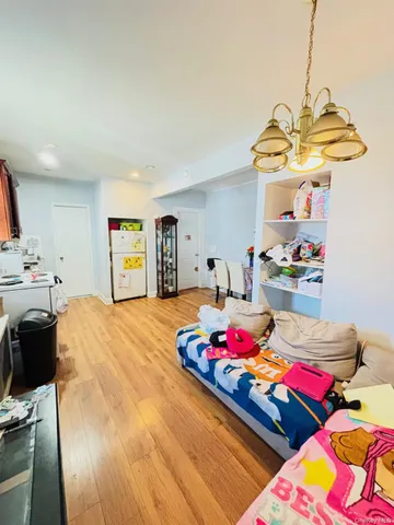a bedroom with bed and a chandelier