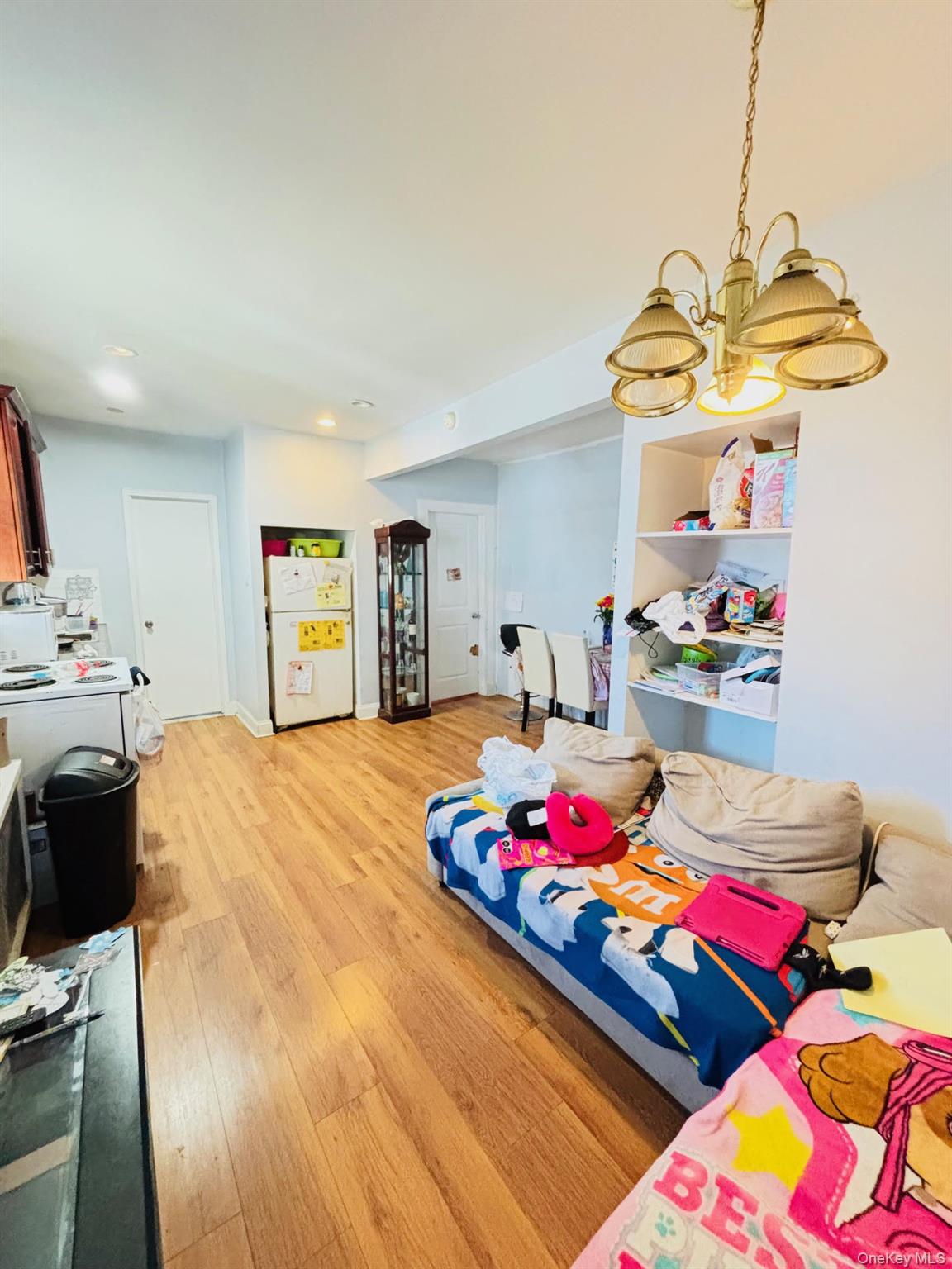 82 Fern Place Inwood, NY 11096 - Photo 10 of 17 a bedroom with bed and a chandelier