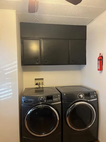a utility room with sink dryer and washer