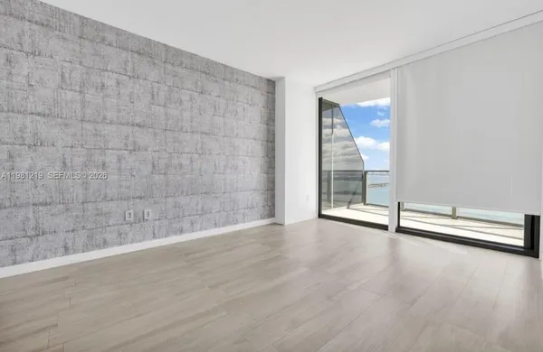 a view of an empty room with glass door