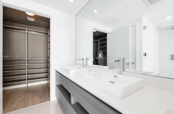 a bathroom with a sink and a large mirror