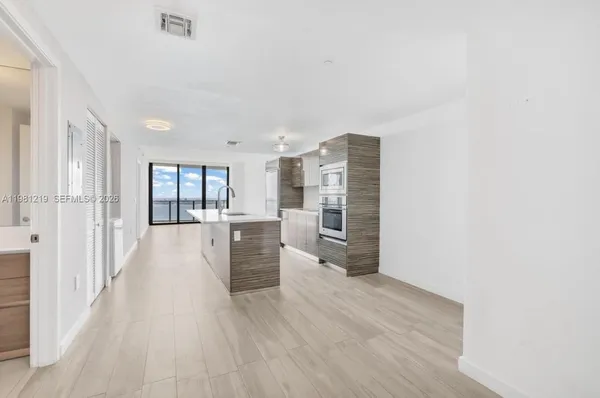 a view of a kitchen with wooden floor and a kitchen