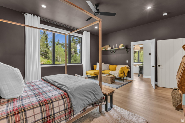 1766 West Tollgate Cyn Road Coalville, UT 84017 - Photo 17 of 59 Expansive windows with black trim, dark accent walls, light wood-finish flooring, a built-in ceiling fan, and recessed lighting