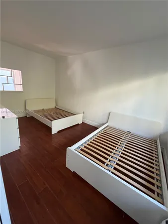a view of room with wooden floor