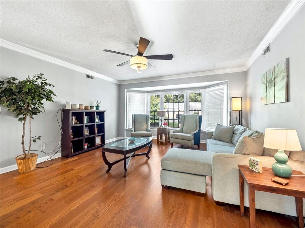 a living room with furniture and a book shelf