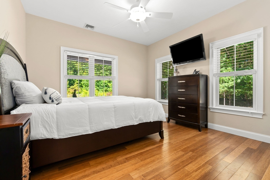 10 Pine Plain Road Georgetown, MA 01833 - Photo 22 of 42 a bedroom with a bed and a flat screen tv