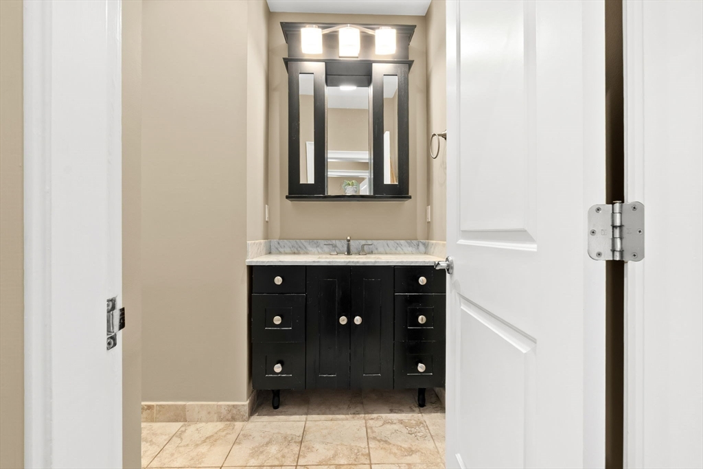 10 Pine Plain Road Georgetown, MA 01833 - Photo 24 of 42 a bathroom with a double vanity sink and mirror