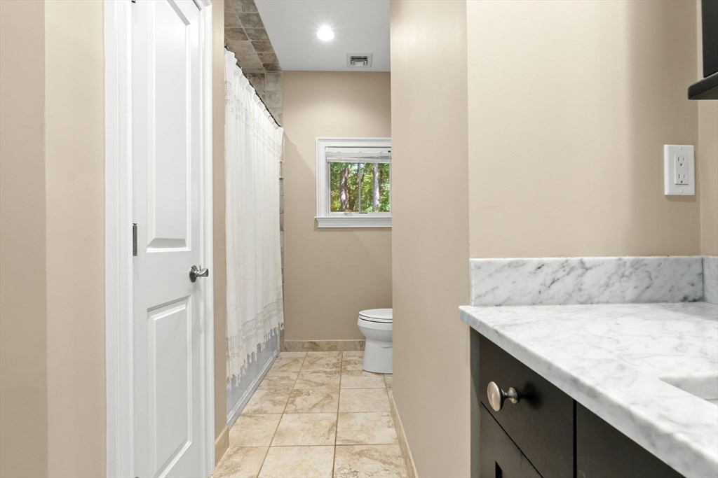 10 Pine Plain Road Georgetown, MA 01833 - Photo 25 of 42 a bathroom with a granite countertop sink and a mirror