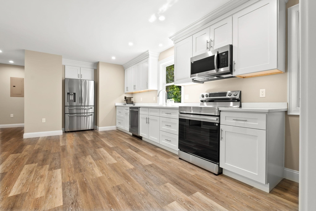 10 Pine Plain Road Georgetown, MA 01833 - Photo 32 of 42 a kitchen with granite countertop a refrigerator stove and microwave