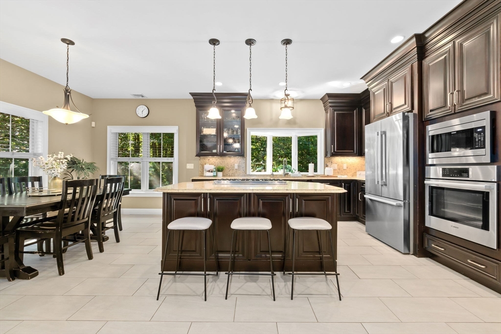 10 Pine Plain Road Georgetown, MA 01833 - Photo 4 of 42 a dinning table and chairs in a kitchen