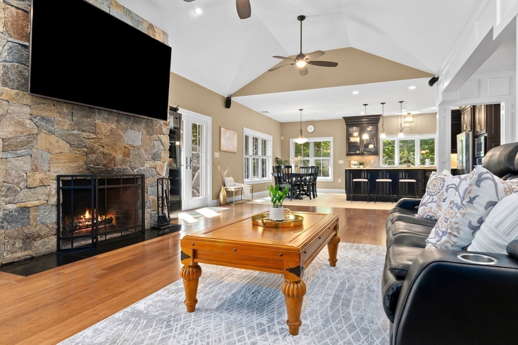10 Pine Plain Road Georgetown, MA 01833 - Photo 9 of 42 a living room with furniture a flat screen tv and a fireplace
