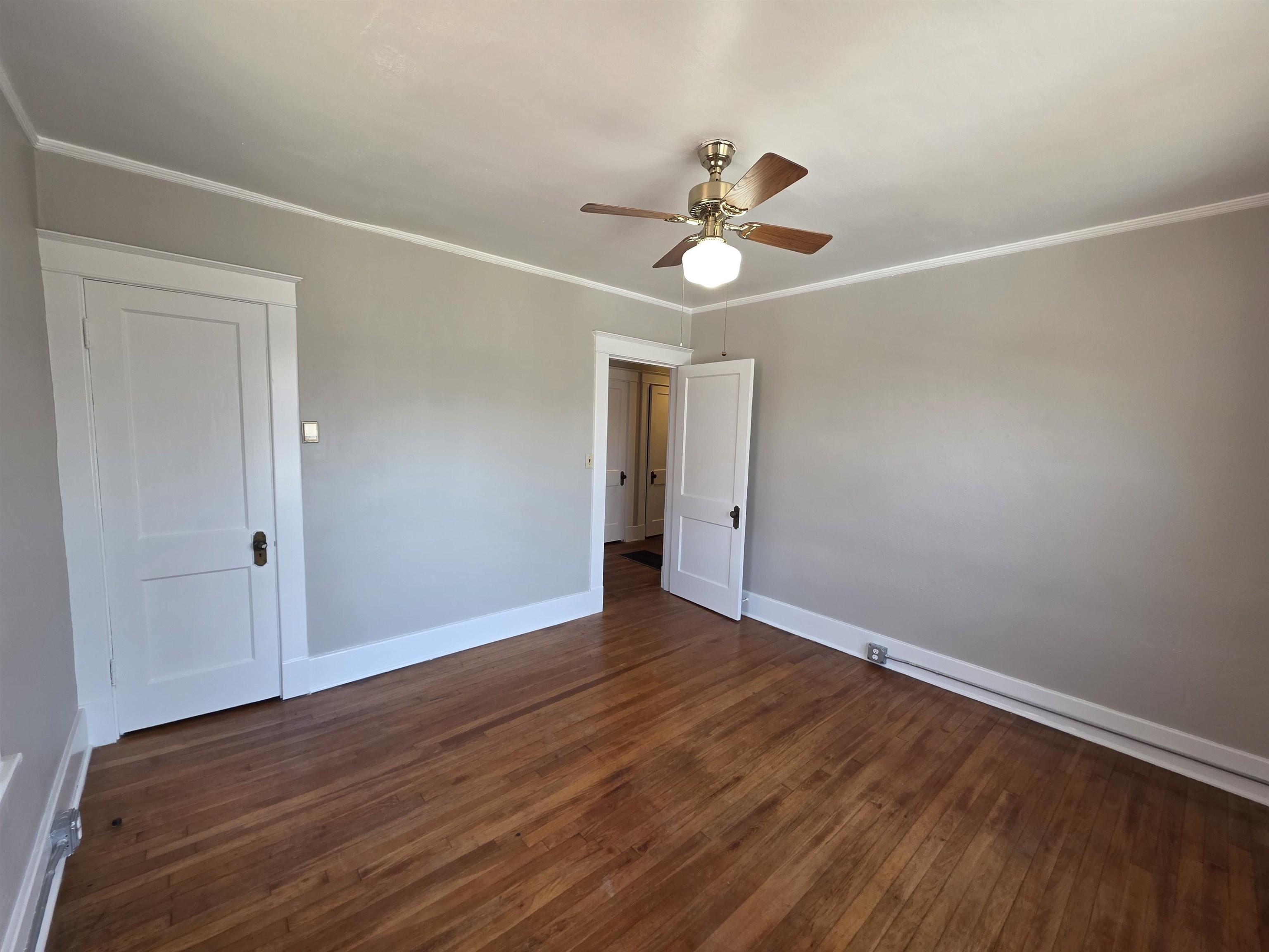 1404 Cameron Street Memphis, TN 38106 - Photo 15 of 37 an empty room with wooden floor fan and windows
