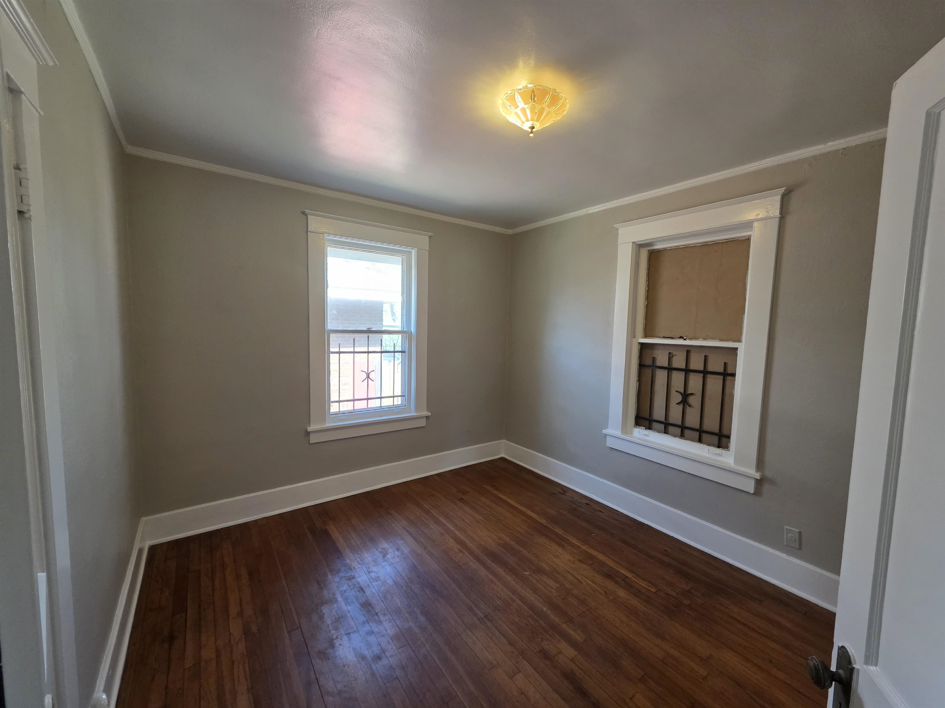 1404 Cameron Street Memphis, TN 38106 - Photo 16 of 37 a view of an empty room with a window and wooden floor