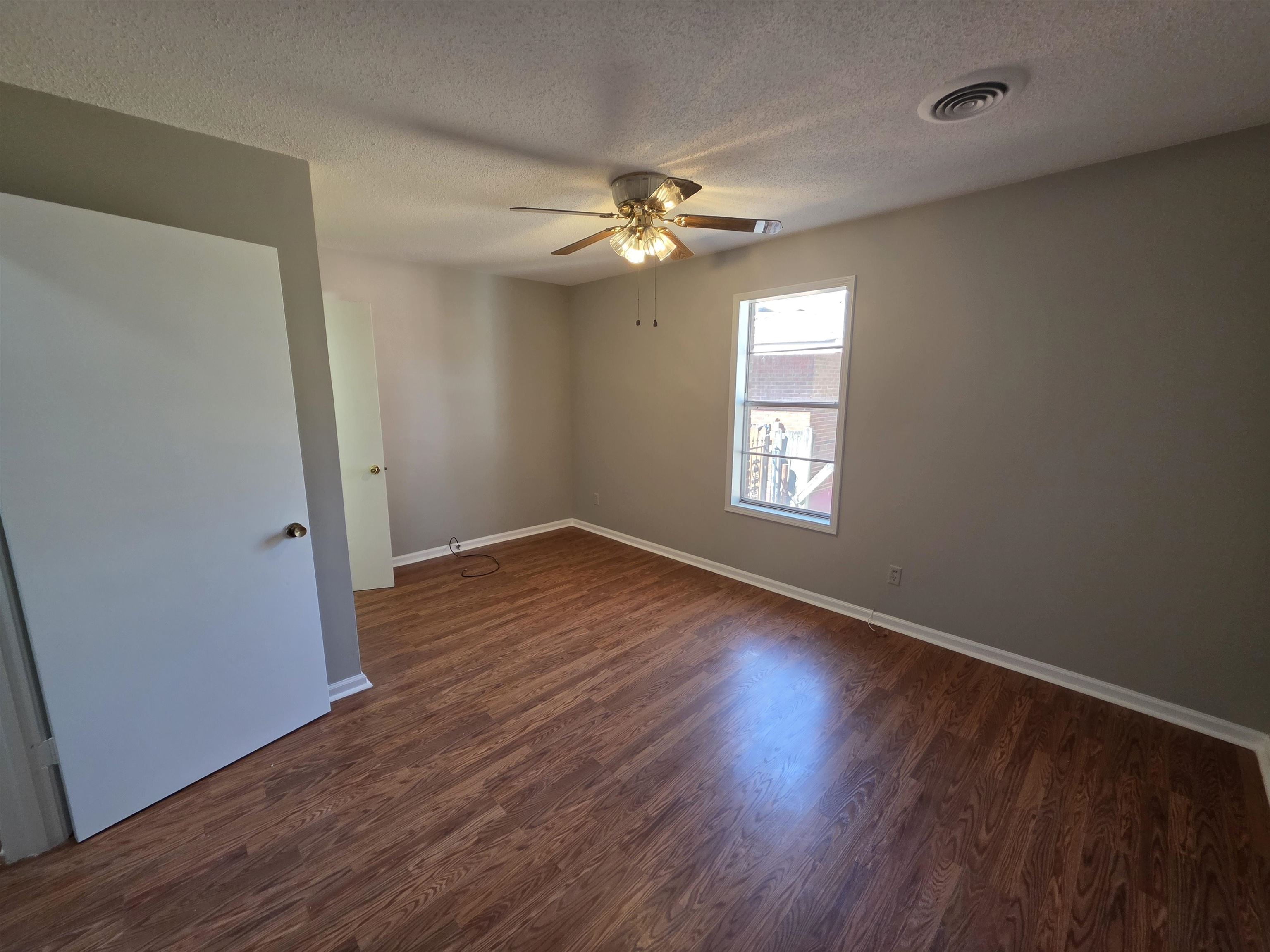 1404 Cameron Street Memphis, TN 38106 - Photo 18 of 37 wooden floor in an empty room with a window
