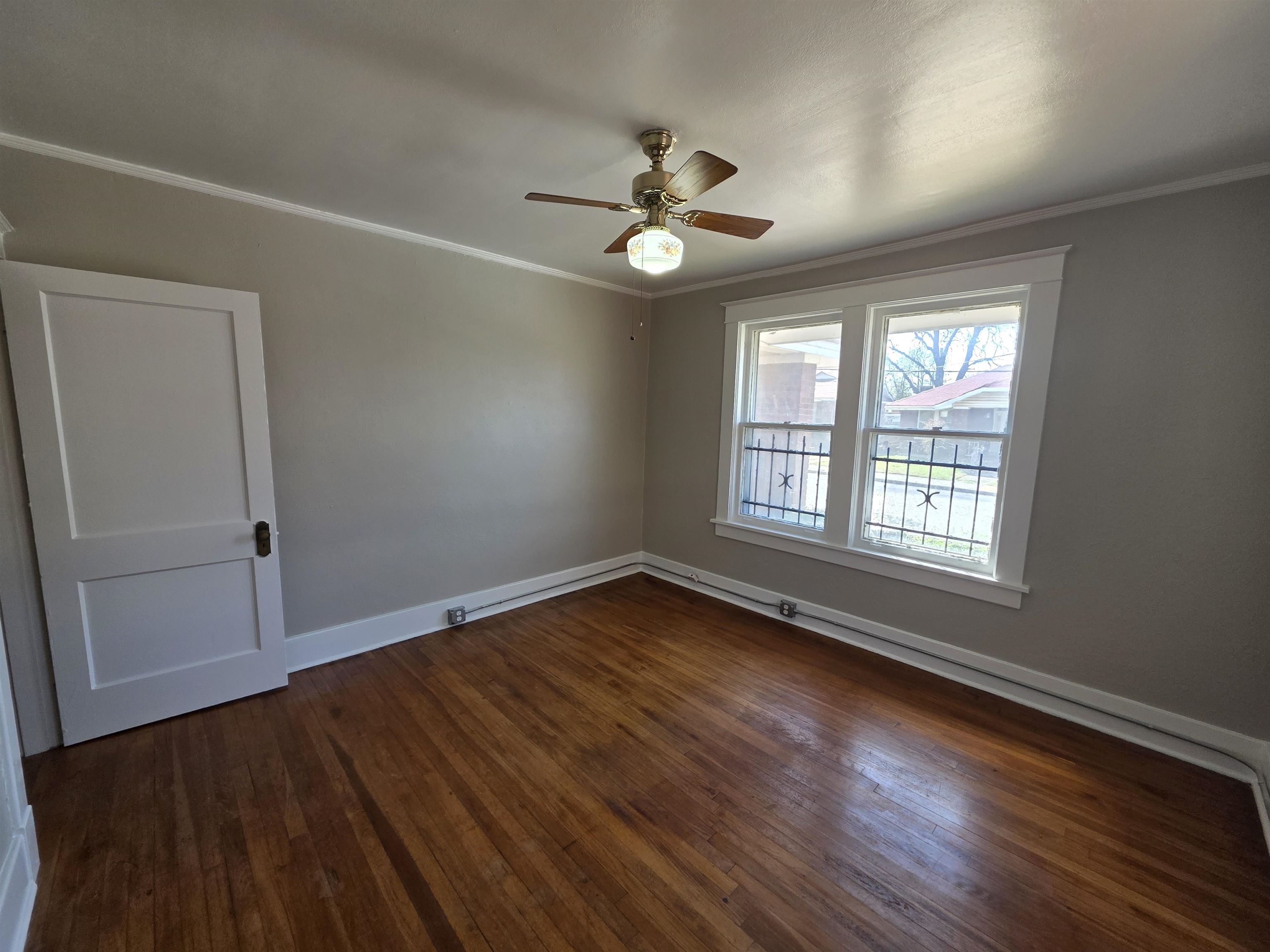 1404 Cameron Street Memphis, TN 38106 - Photo 19 of 37 a view of an empty room with wooden floor and a window