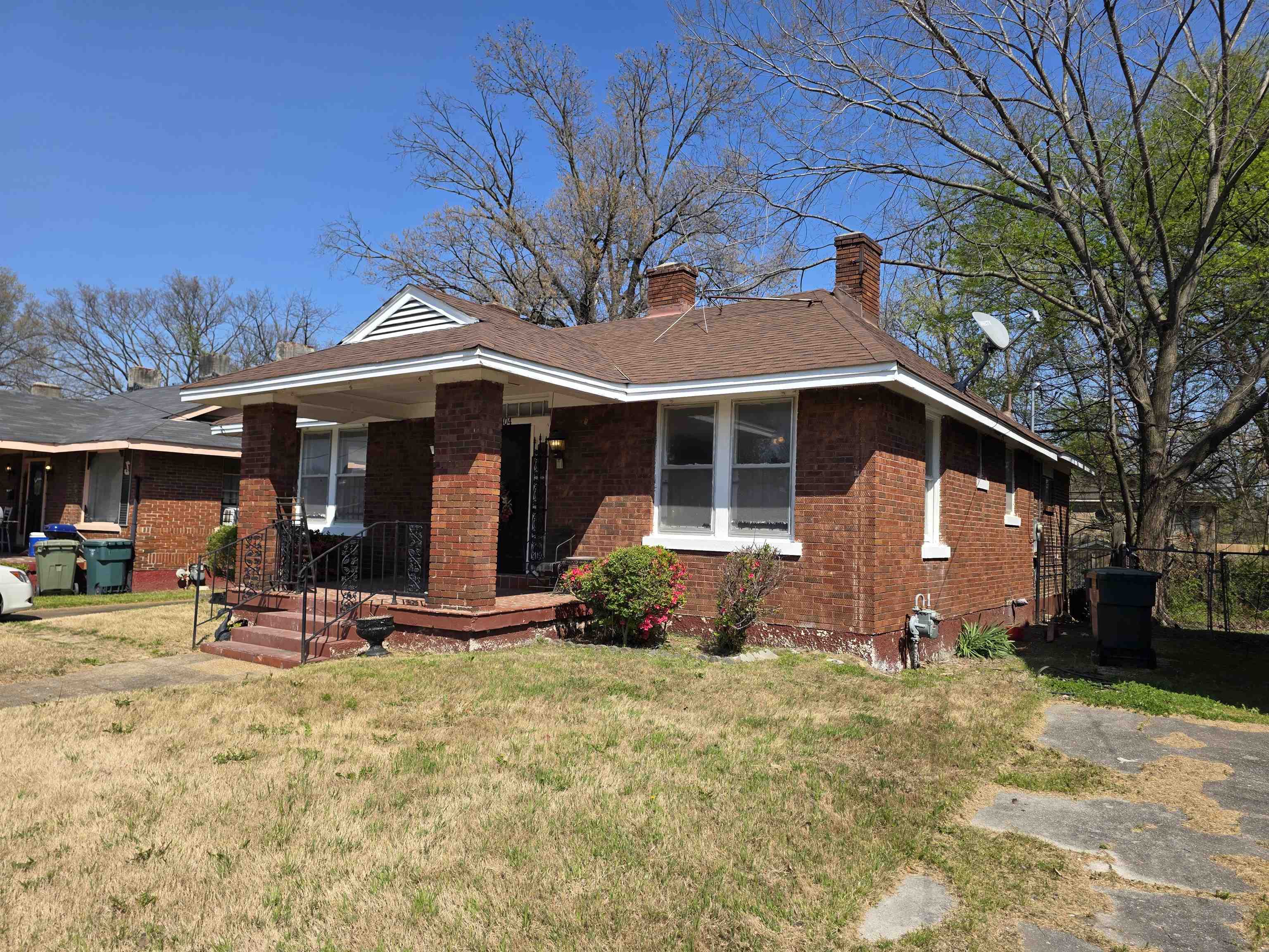 1404 Cameron Street Memphis, TN 38106 - Photo 2 of 37 a front view of a house with a yard outdoor seating and covered with trees