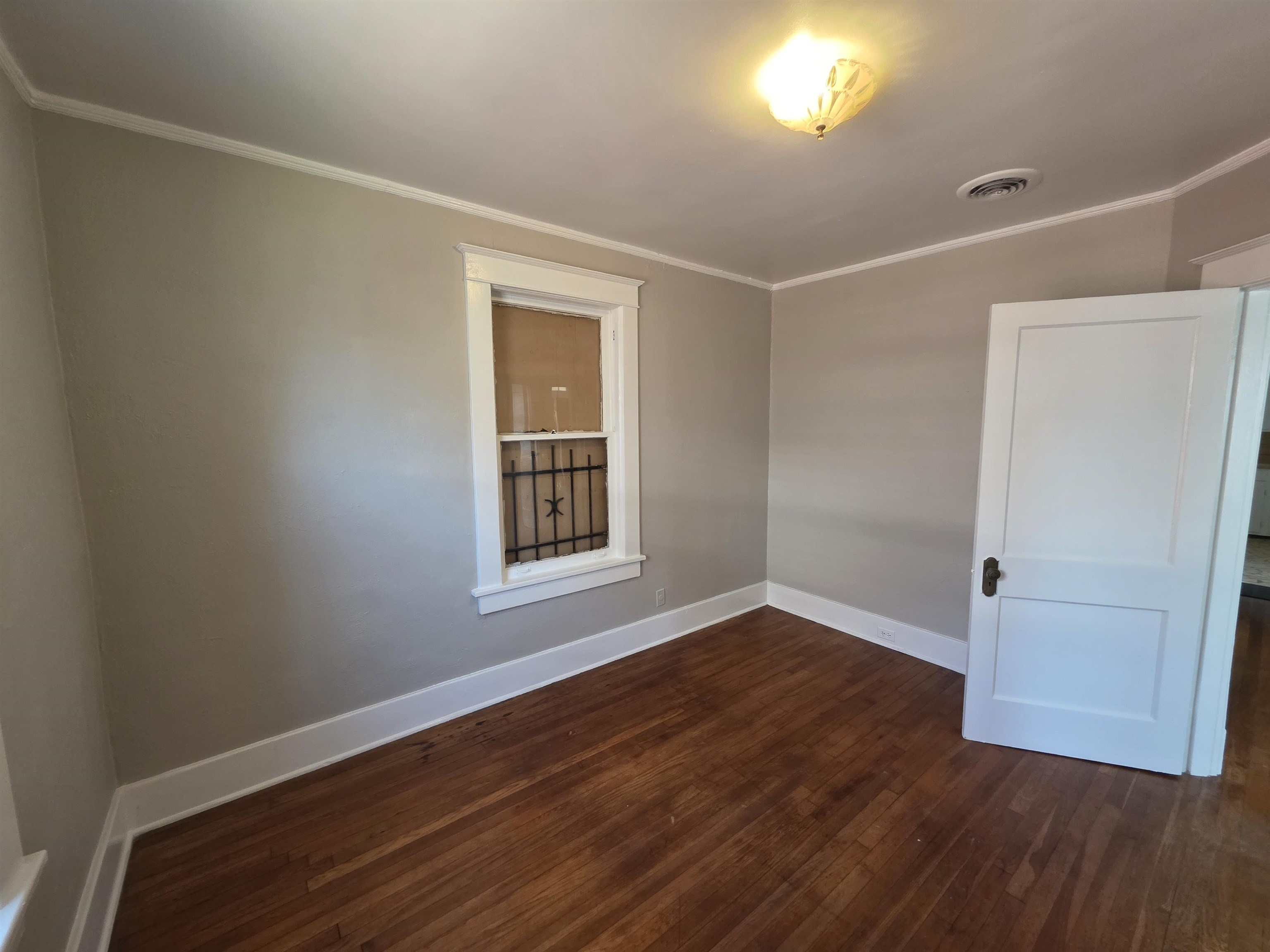 1404 Cameron Street Memphis, TN 38106 - Photo 21 of 37 an empty room with wooden floor and windows