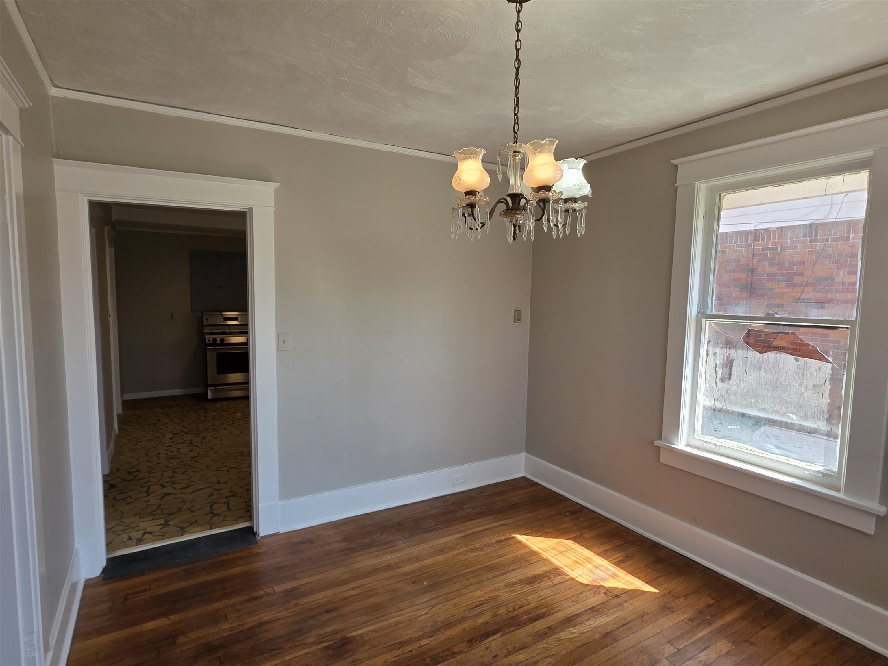 1404 Cameron Street Memphis, TN 38106 - Photo 31 of 37 a view of a room with wooden floor chandelier and windows