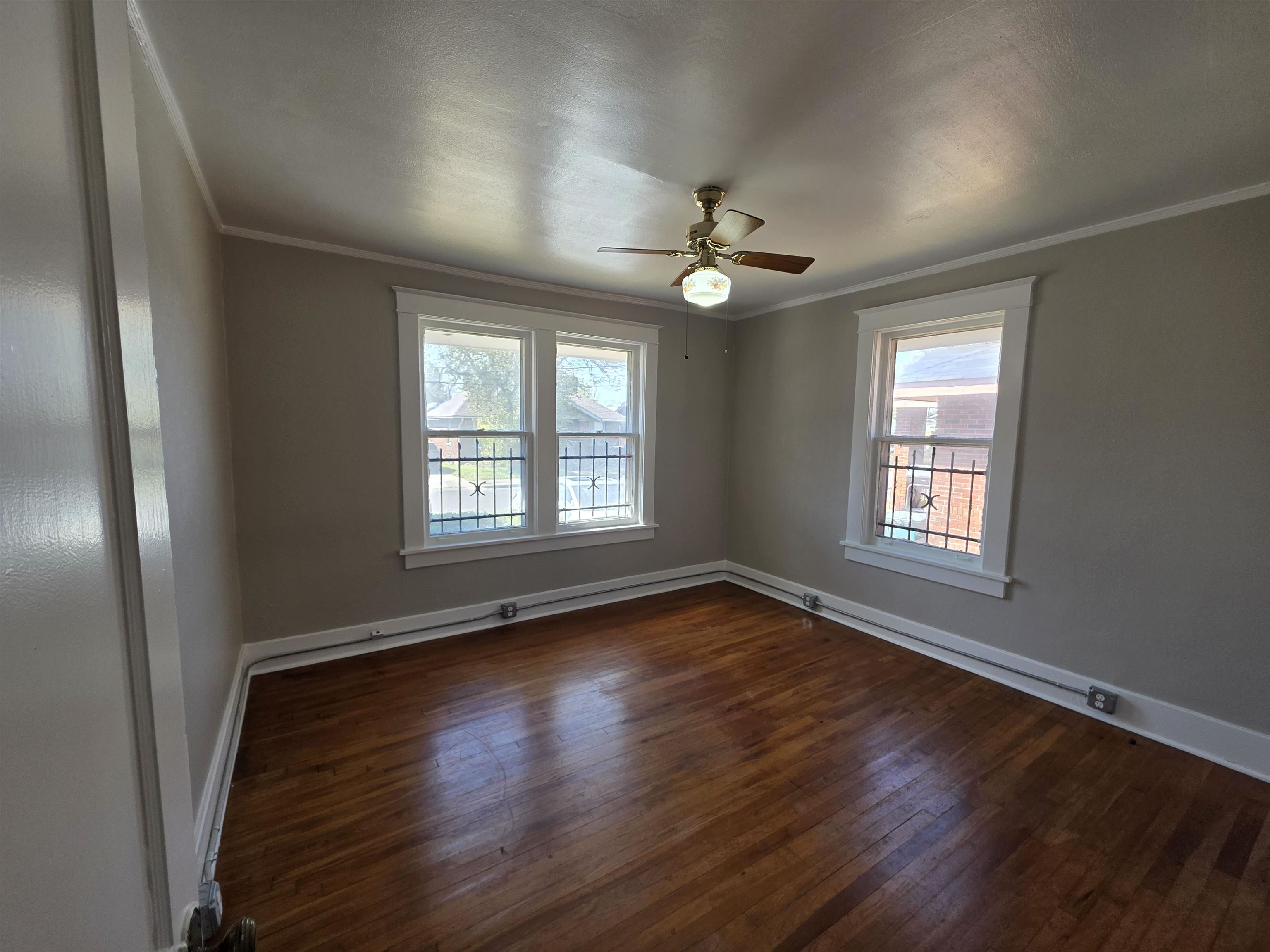 1404 Cameron Street Memphis, TN 38106 - Photo 7 of 37 a view of an empty room with wooden floor and a window