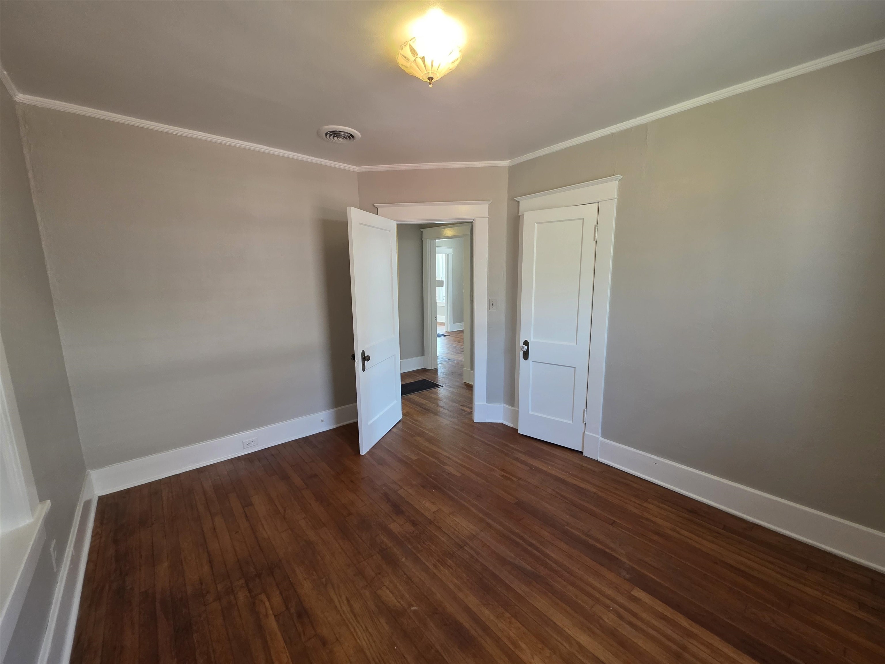 1404 Cameron Street Memphis, TN 38106 - Photo 8 of 37 a view of an empty room with wooden floor and a window