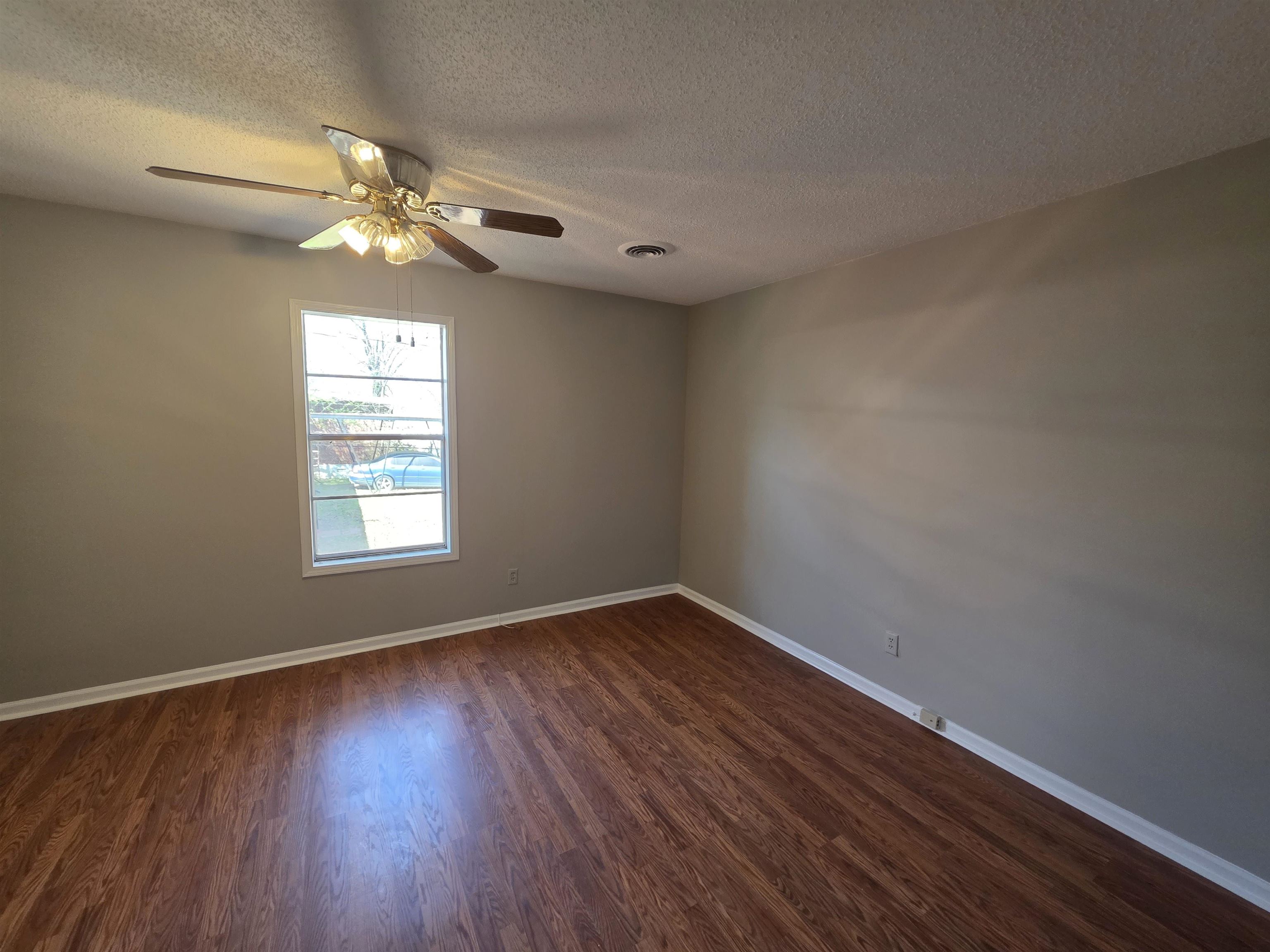1404 Cameron Street Memphis, TN 38106 - Photo 10 of 37 a view of an empty room with wooden floor and a window