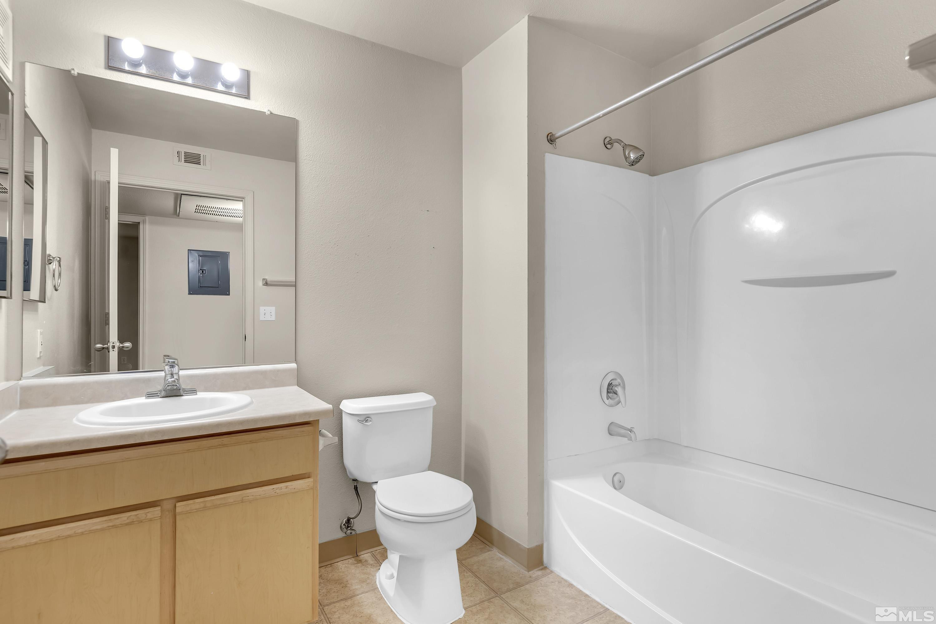 6850 Sharlands Avenue, Unit 2120 Reno, NV 89523 - Photo 13 of 35 a bathroom with a sink mirror toilet and bathtub