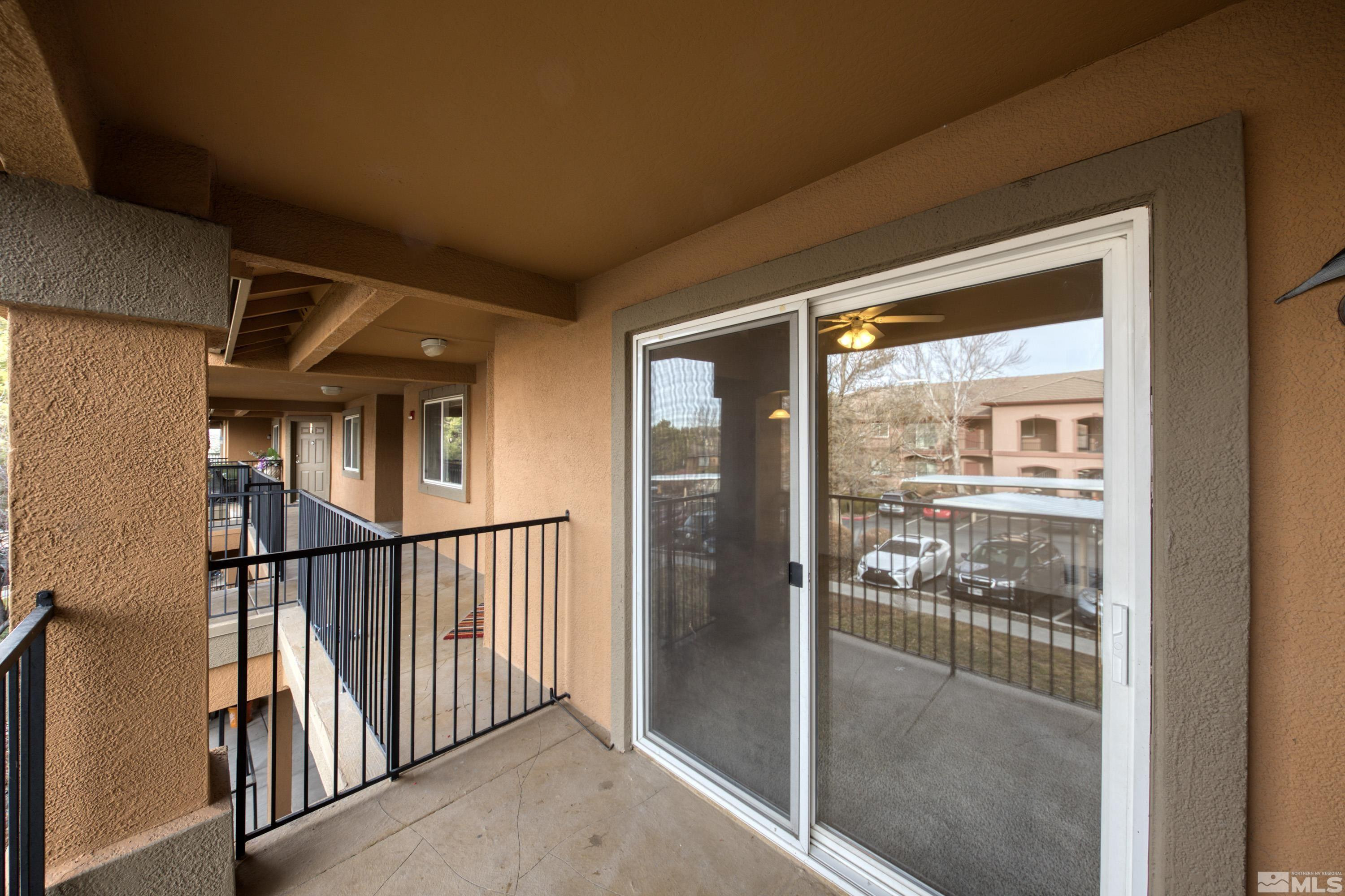 6850 Sharlands Avenue, Unit 2120 Reno, NV 89523 - Photo 20 of 35 a view of a hallway with wooden floor and a window