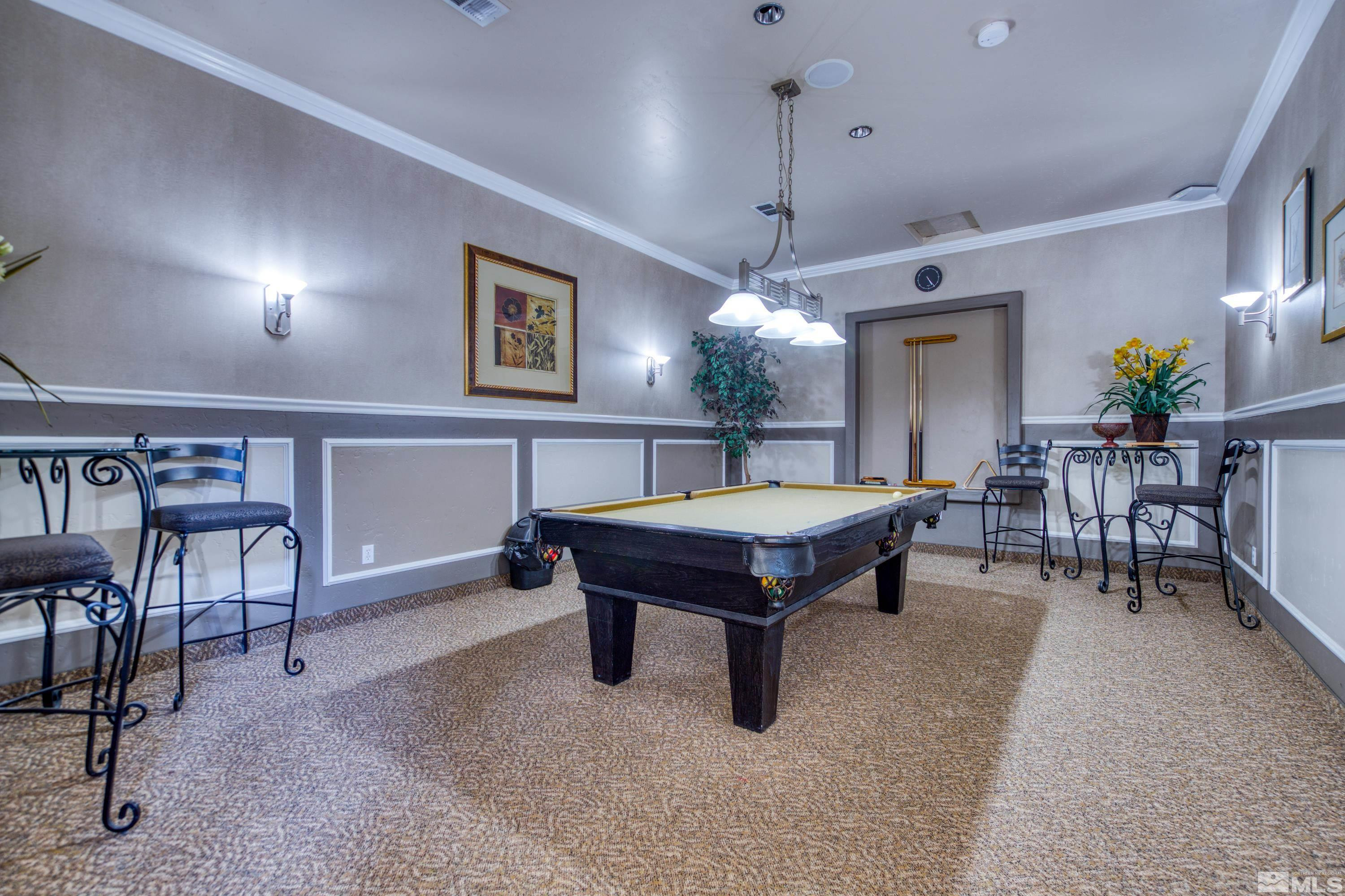 6850 Sharlands Avenue, Unit 2120 Reno, NV 89523 - Photo 31 of 35 a living room with furniture a table and a chandelier