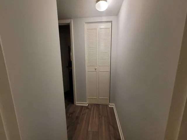 a view of a room with wooden floor