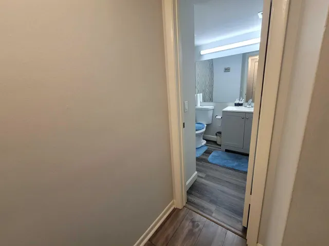 a view of a bathroom from a hallway
