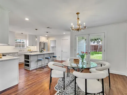 a view of a dining room with furniture wooden floor and chandelier