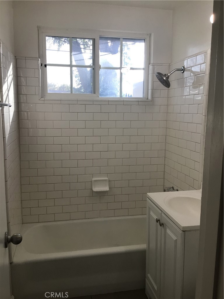 1202 West Lumber Street Lancaster, CA 93534 - Photo 12 of 16 a bathroom with a sink a toilet and shower