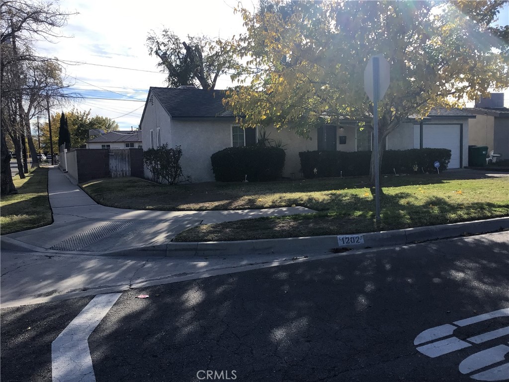 1202 West Lumber Street Lancaster, CA 93534 - Photo 2 of 16 a front view of a house with garden
