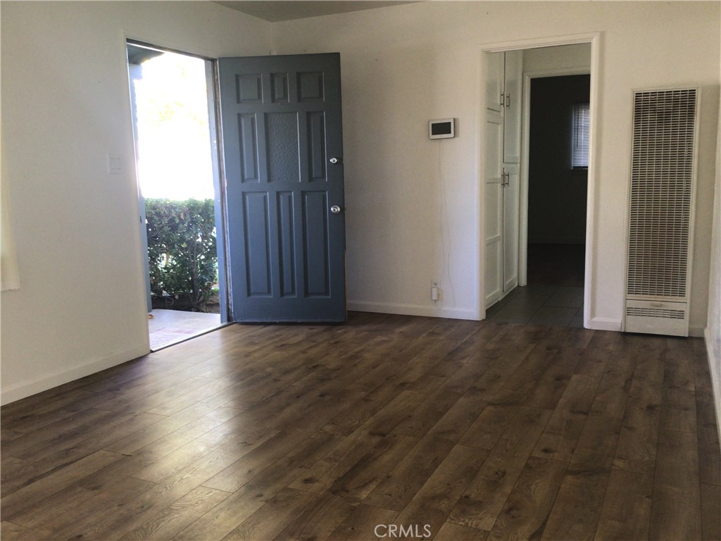 1202 West Lumber Street Lancaster, CA 93534 - Photo 5 of 16 an empty room with wooden floor and windows