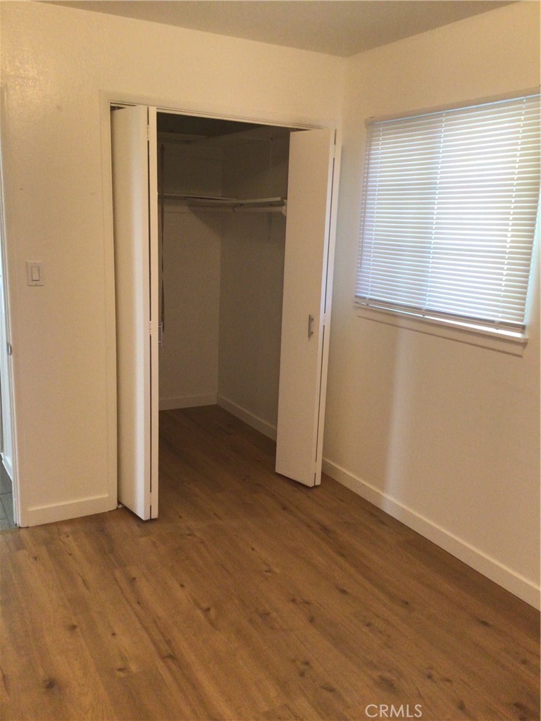 1202 West Lumber Street Lancaster, CA 93534 - Photo 10 of 16 an empty room with wooden floor and closet