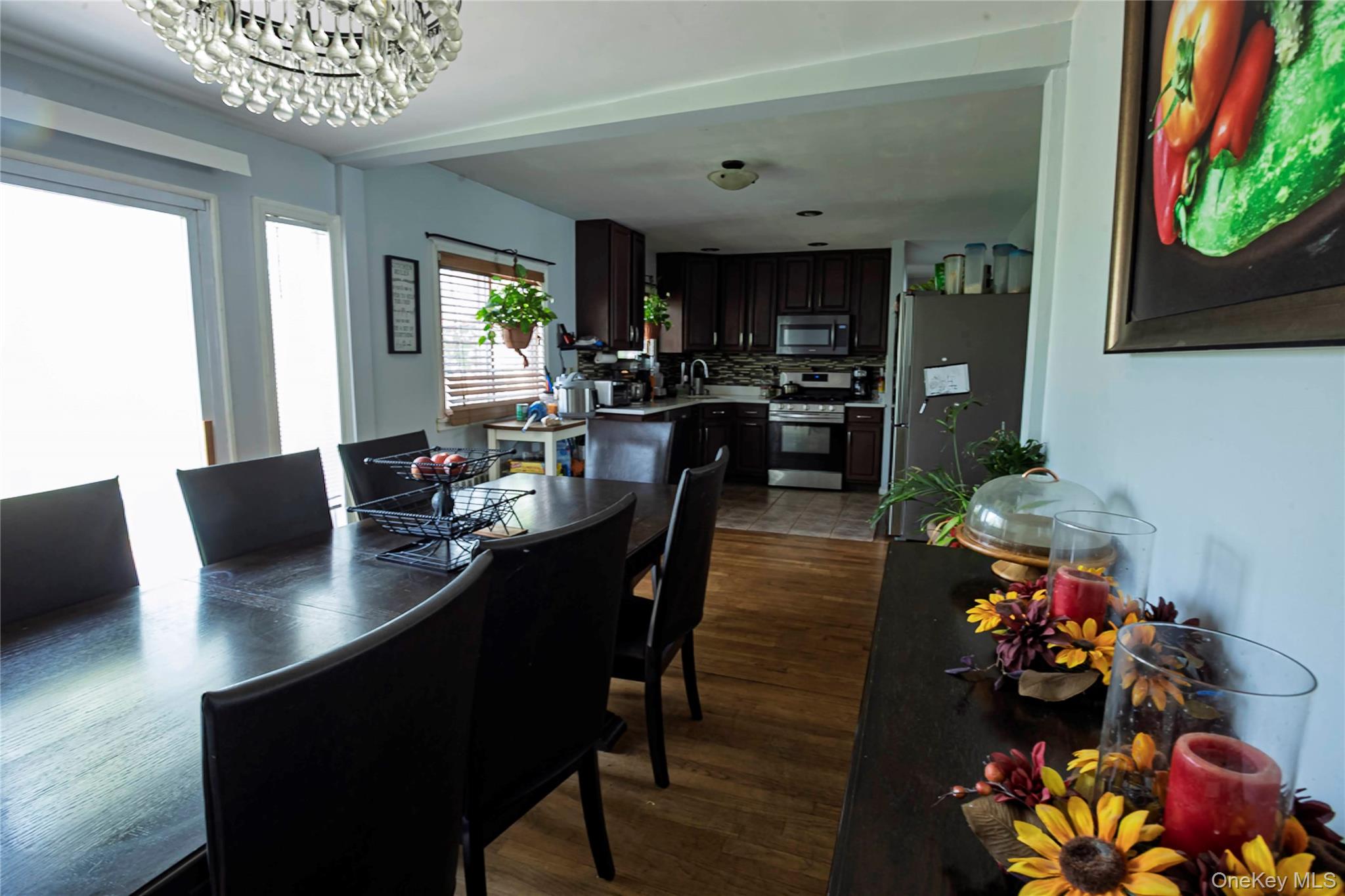 2687 Fox Road Baldwin, NY 11510 - Photo 12 of 27 a view of a dining room with furniture and a potted plant