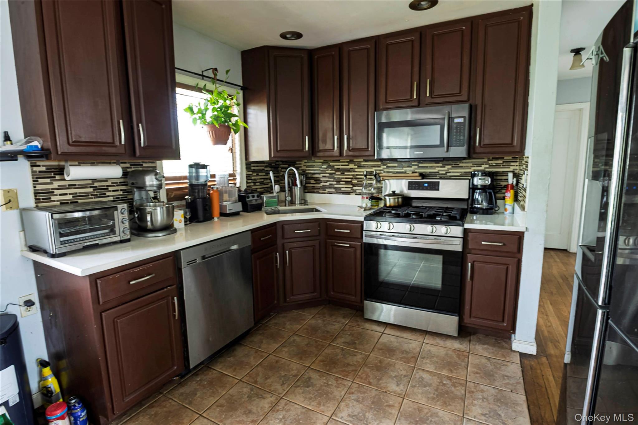 2687 Fox Road Baldwin, NY 11510 - Photo 13 of 27 a kitchen with stainless steel appliances granite countertop a stove a sink dishwasher and a refrigerator