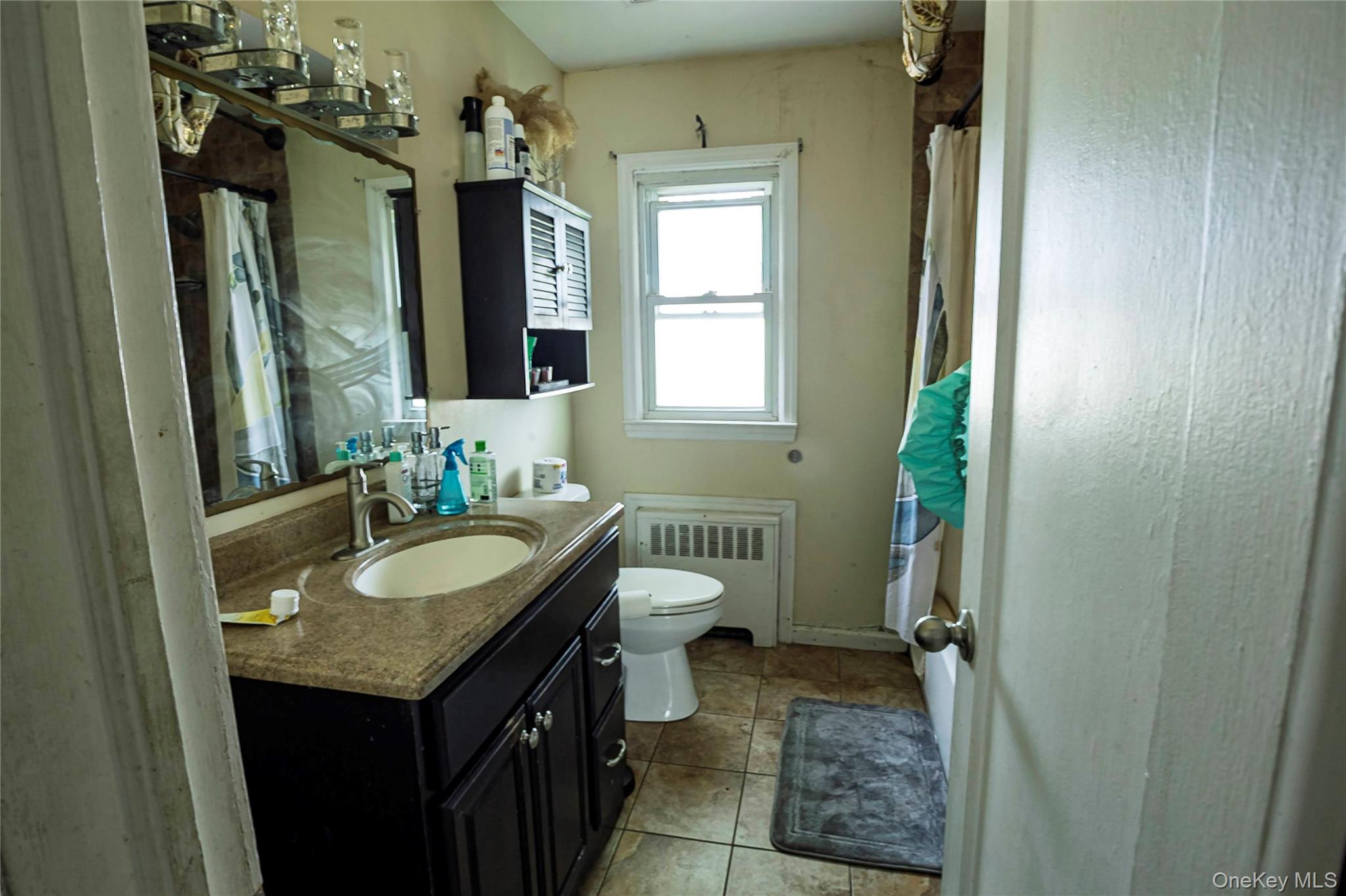 2687 Fox Road Baldwin, NY 11510 - Photo 14 of 27 a bathroom with a granite countertop sink and a mirror
