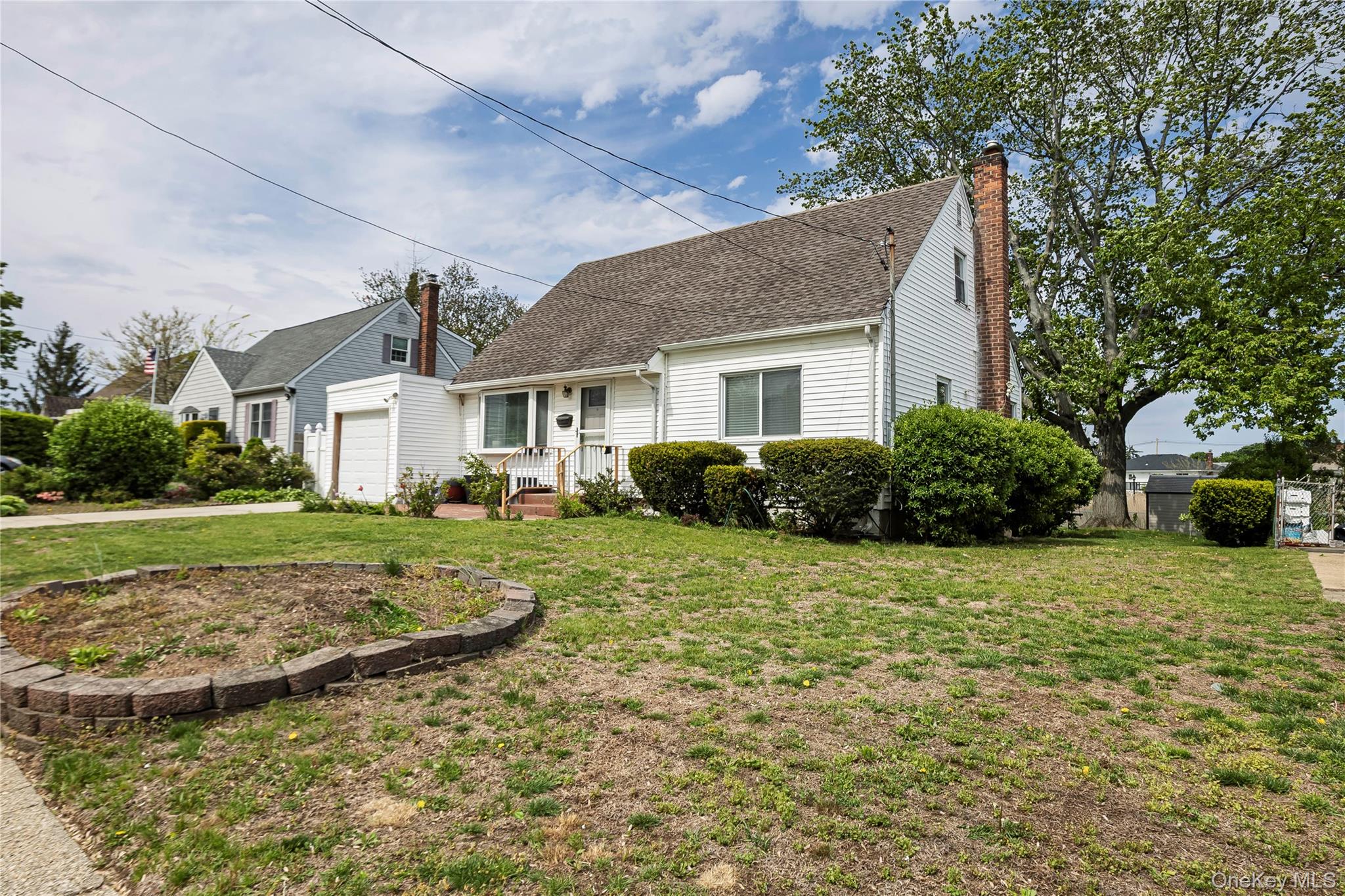 2687 Fox Road Baldwin, NY 11510 - Photo 2 of 27 a front view of a house with garden