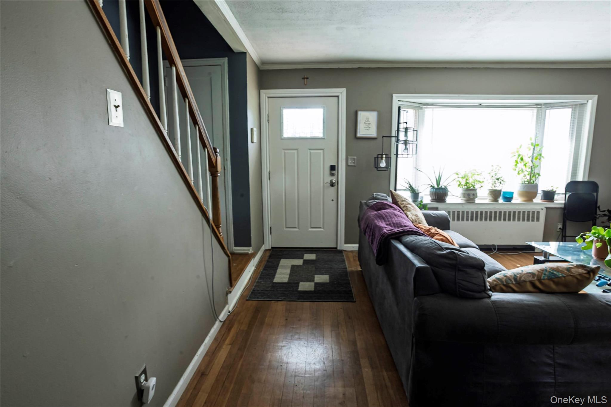 2687 Fox Road Baldwin, NY 11510 - Photo 10 of 27 a living room with furniture and a floor to ceiling window