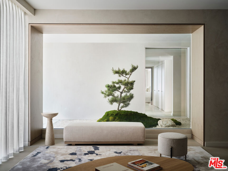 a living room with furniture and a potted plant