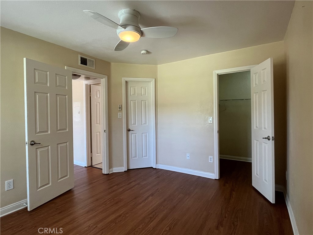 2160 Highpointe Drive, Unit 112 Corona, CA 92879 - Photo 11 of 21 an empty room with wooden floor and windows