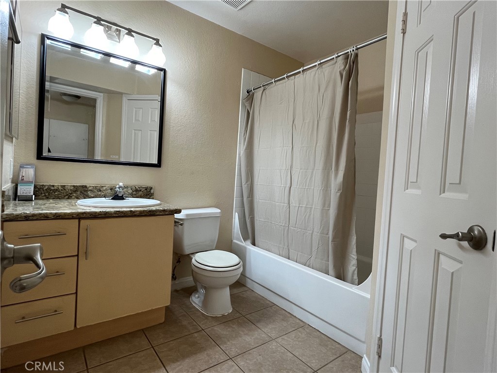 2160 Highpointe Drive, Unit 112 Corona, CA 92879 - Photo 9 of 21 a bathroom with a granite countertop sink toilet and shower