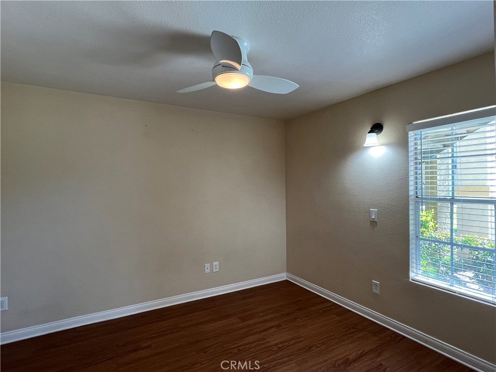 2160 Highpointe Drive, Unit 112 Corona, CA 92879 - Photo 10 of 21 a view of an empty room with wooden floor and a window