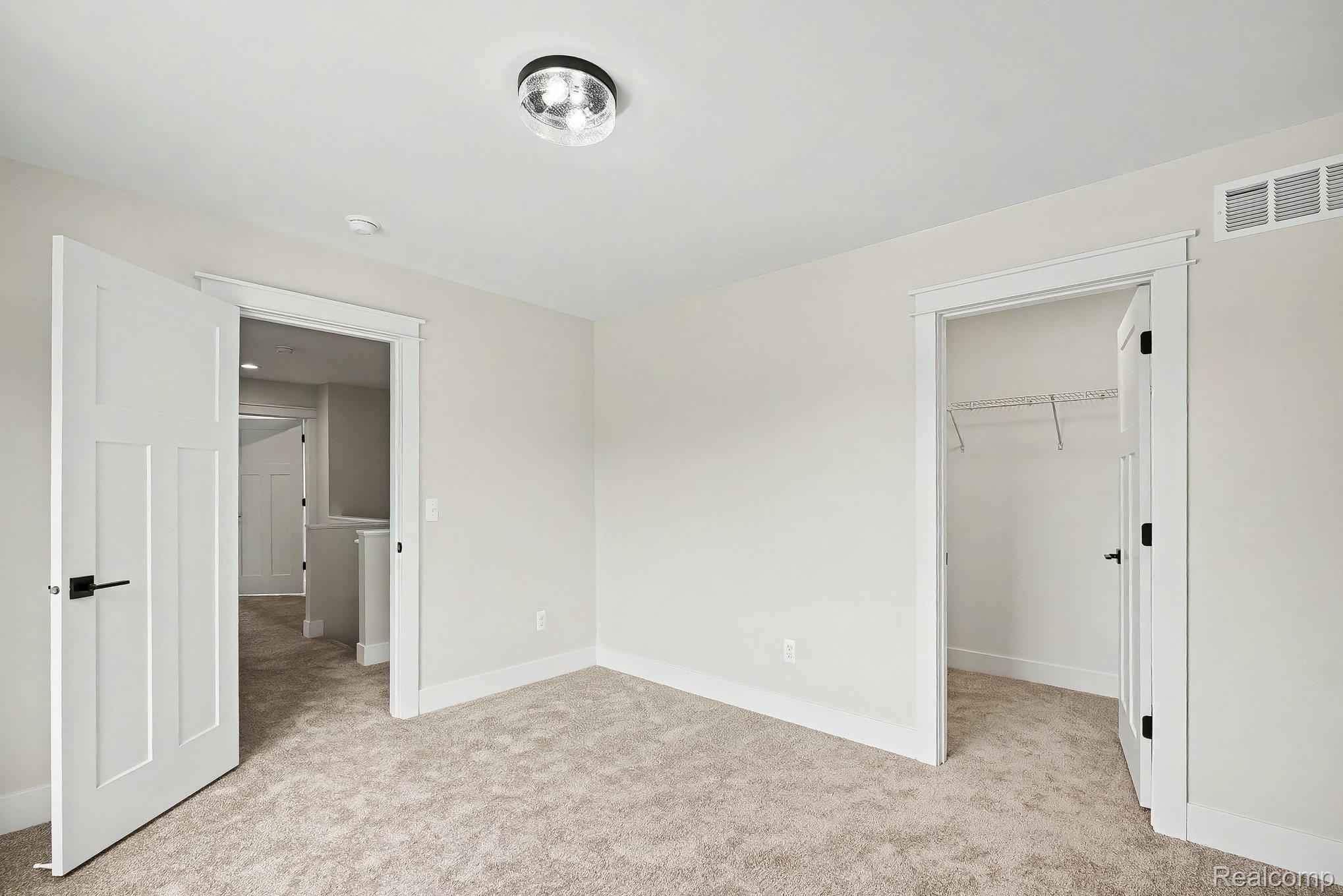 57560 Omo Road Ray, MI 48096 - Photo 26 of 44 Upper level bedroom 2. Neutral-toned room featuring light beige walls and carpeting