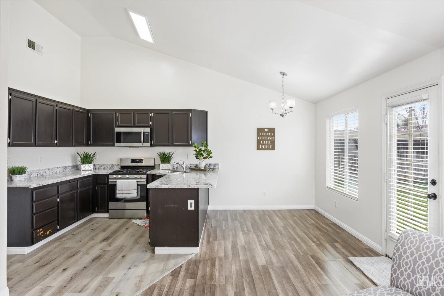 Undisclosed Address Bakersfield, CA 93307 - Photo 15 of 35 a kitchen with stove and cabinets